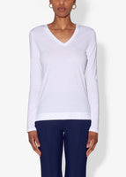 Model is wearing a white long sleeve v-neck t-shirt in pima cotton.