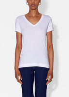Model wears white short sleeve v-neck t-shirt in pima cotton.