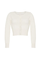 A flat lay of an ivory longsleeve cashmere cardigan with small crystal flower buttons on the front.