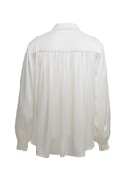 A flat lay of the back of the ivory Blouse with Pearls in Silk Charmeuse.