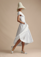 An image of a model flaring the base of the Sibyl Dress in Cotton Poplin.
