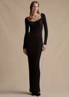 Model is wearing the black silk cashmere ribbed knit version of the Florentine Dress. The dress has long sleeves and hits at the ankle.