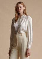 Model is wearing the ivory blouse with pearls in silk charmeuse tucked into the ivory silk wool Deeda trouser.