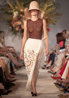 Model is facing forward wearing a lightweight metallic sleeveless knit top, in a decorative rib stitch, while walking in a runway show.