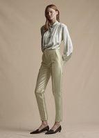 Model is wearing the pistachio blouse with pearls in silk charmeuse tucked into the pistachio Harper silk mikado pant.