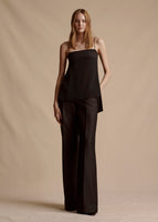 Model is wearing the black Cami Top with fringe in silk crepe, paired with the black Bettina Pant in wool.