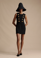 A model wearing the Mini Aubrey Dress in Wool Crepe, paired with the Cleo Hat.