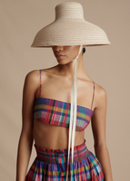Close up of model wearing the Taiko Hat, Bandeau in Printed Tussah Silk, and the Lovisa Skirt with Smocked Waist in Printed Voile.