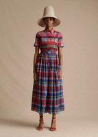 A model facing forward wearing the Smocked Waist Skirt in Printed Voile, styled with the Trapeze Shirt in Printed Voile and the Cleo Hat.