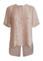A flat lay image of a pink sequined t-shirt.
