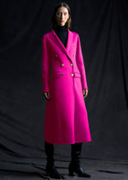 A model wearing a hot pink coat with gold buttons.