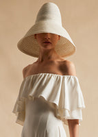A model facing forward wearing an oversized bucket hat.