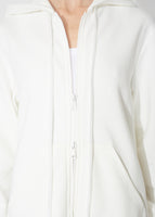 A detailed view of an ivory hooded zip up dress.