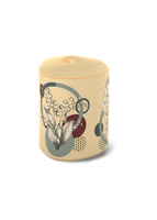 A cream colored candle with leaf and geometric prints. 