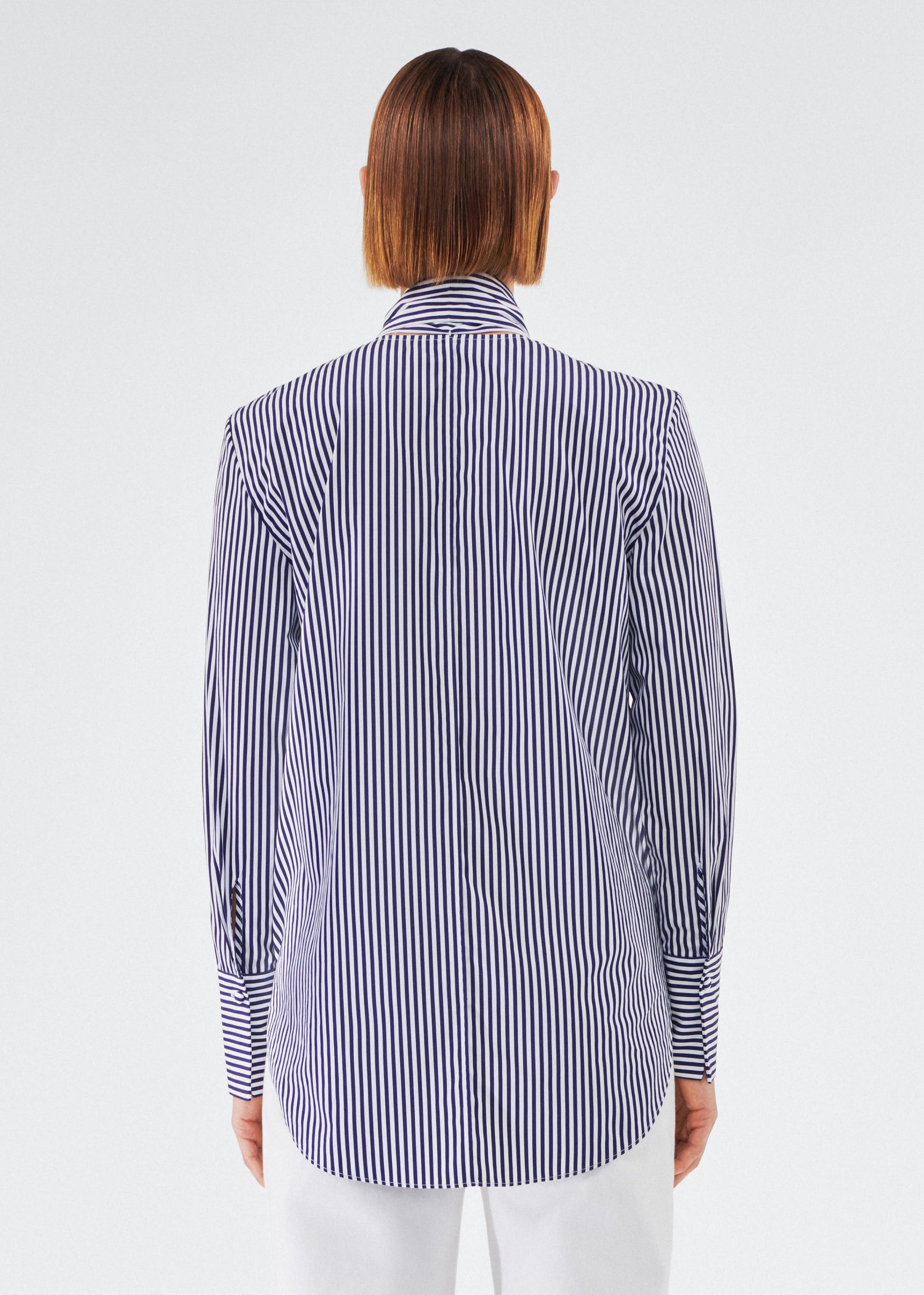 back view of model wearing lee blouse by adam lippes in striped poplin in navy and white