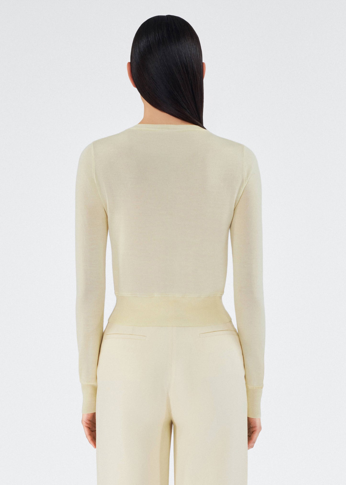 back view of model wearing the adam lippes cardigan in cashmere silk in beurre