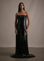Model wearing long black floor length sequin bustier gown. 