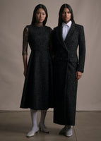 Two models on the right wearing a lace long sleeve top under a black metallic fit and flare dress. On the right a white shirt under a black metallic overcoat. 