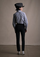 Image of model facing backwards wearing striped shirt tucked into black cigarette pants.