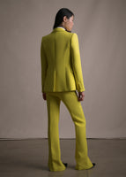 A back-facing image of model wearing citrine single breasted blazer with matching citrine pants.