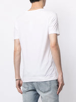 Model is wearing a white short sleeve v-neck t-shirt in pima cotton.