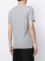 Model is wearing a gray short sleeve v-neck t-shirt in pima cotton.