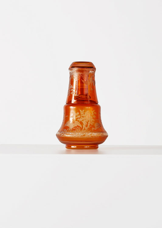 Amber colored vintaga carafe and cup, with bird and flora motif decoration