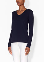 Model is wearing a navy long sleeve v-neck t-shirt in pima cotton.