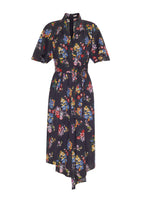 Flat lay of mid length black short sleeve asymmetrical dress with a tie front and multicolor printed flowers in voile.