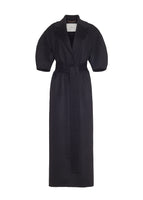Flat lay of a long black regency coat with short balloon sleeves and a front waist tie in double face cashmere. 