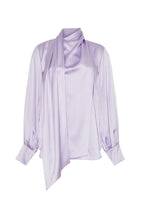Flat lay of a lavender long sleeve silk charmeuse blouse with an asymmetrical wrap front.