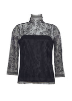 A ghost image of a black lace turtleneck with a black cami underneath it. 