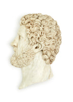 A marble sculpture of a mans neck, head, and face.