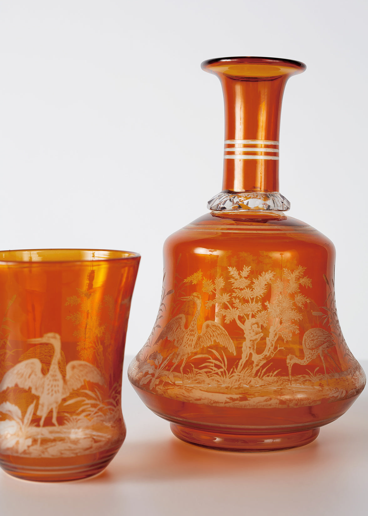 close up image of Hand engraved amber glass "Upside Down." Baccarat, c. 1890.