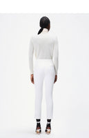 model wearing the cigarette pant in white in stretch cady