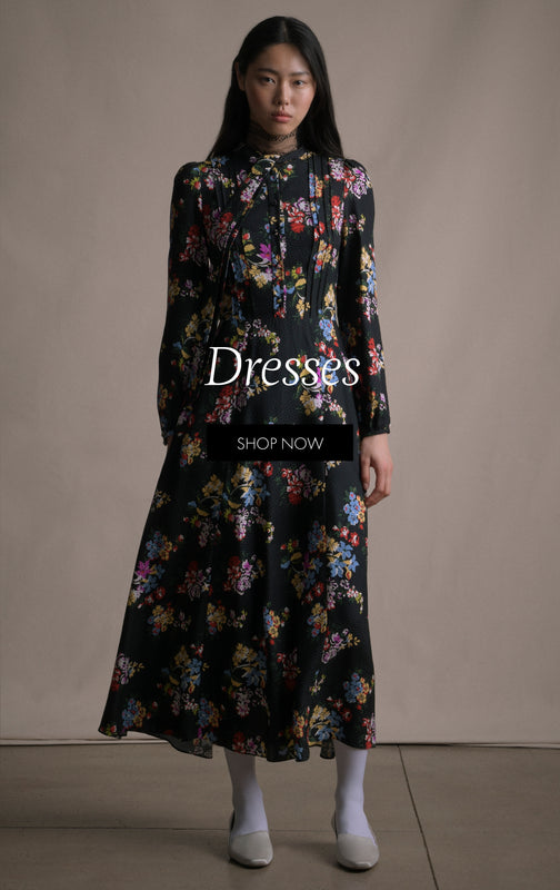 Dresses. Shop Now. An image of a model facing forward wearing a black floral long dress.