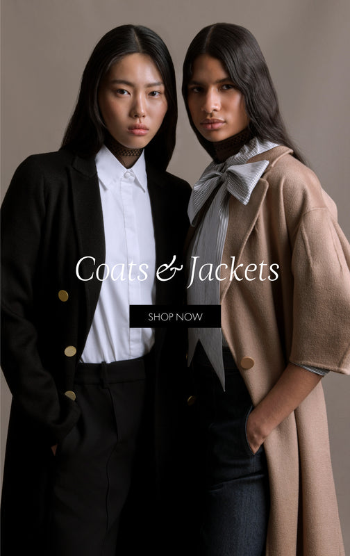 Coats & Jackets. Shop Now. An image of two models facing forward, the one on the right is wearing a camel jacket and the one on the left is wearing a black jacket and the one on the right is wearing a camel jacket.