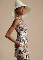 A side image of a model wearing the Sheath Dress in Printed Cotton Twill, paired with the Cleo Hat.