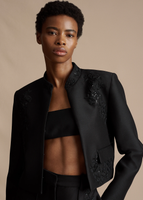 Close up of the model wearing the Embroidered Bolero in Radzimir Wool with the Embroidered Deeda Pant in Radzimir Wool.