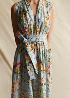 A close-up oof the pleating and self fabric belt on the blue floral printed sleeveless dress.