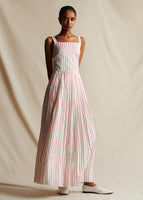 An image of a model wearing a long red and white striped sleeveless dress.