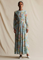 Image of a model facing forwards wearing pale blue floral long sleeved dress.