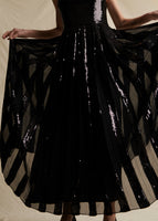 Model showing the striped sequins of a sequinned dress.