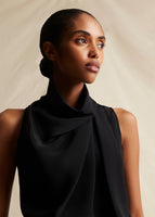 Image of a model from the waist up, wearing a black sleeveless top.