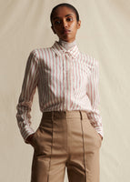Image of a model wearing a red and white striped long sleeved collared shirt tucked into khaki pants.