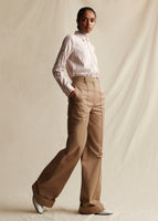 A model stands wearing a khaki wide leg pant, styled with a red and white striped shirt.