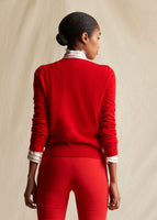 A model standing backwards wearing a red crew  neck sweater with red pants.