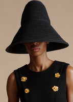 Cropped in image of a model wearing a black hemp hat with a sleeveless black dress.