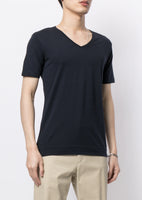 Model is wearing a black short sleeve v-neck t-shirt in pima cotton.