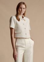 Model is wearing the ivory Cropped Marseille Jacket in Silk Wool with the matching ivory Silk Wool Deeda pant.